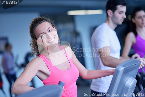 Image of Group of people running on treadmills