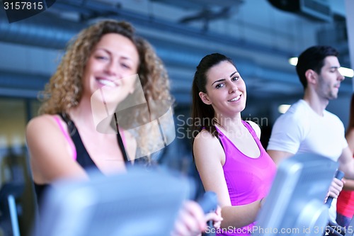 Image of Group of people running on treadmills