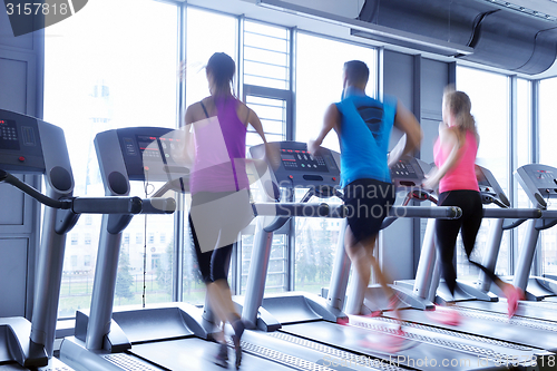 Image of Group of people running on treadmills