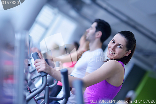 Image of Group of people running on treadmills