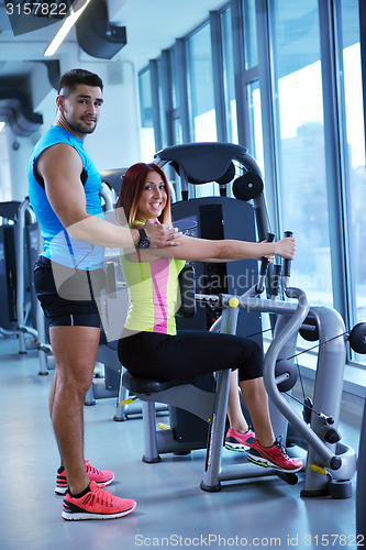 Image of woman exercising with her personal trainer