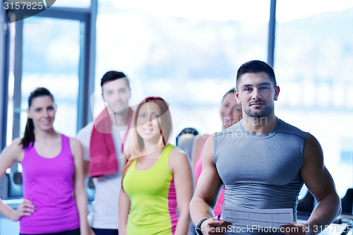 Image of Group of people exercising at the gym