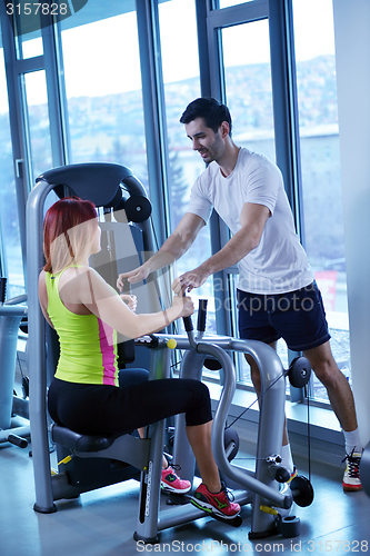 Image of woman exercising with her personal trainer