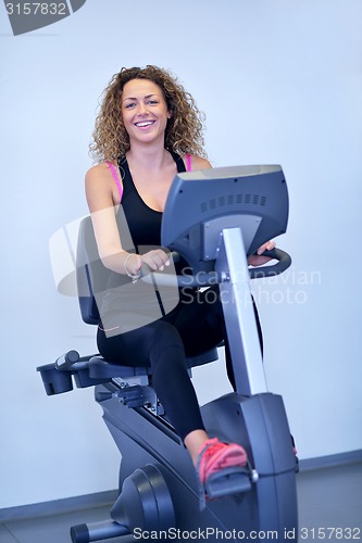 Image of woman exercising on treadmill in gym