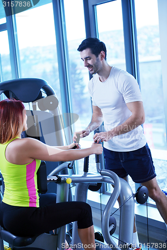 Image of woman exercising with her personal trainer