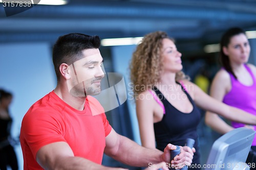 Image of Group of people running on treadmills