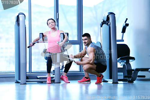 Image of woman exercising with her personal trainer