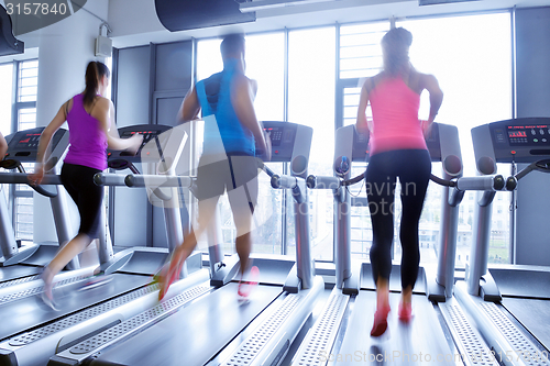 Image of Group of people running on treadmills