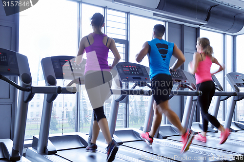 Image of Group of people running on treadmills