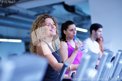 Image of Group of people running on treadmills