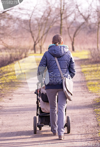 Image of Young mother with  pram 