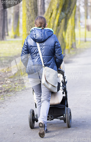 Image of Young mother with  pram 