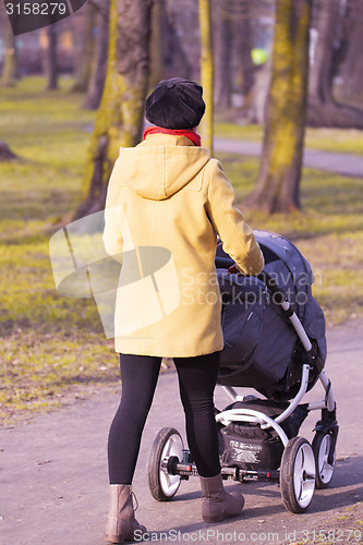 Image of Young mother with  pram 