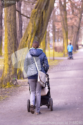 Image of Young mother with  pram 