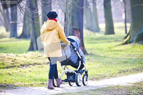 Image of Young mother with  pram 