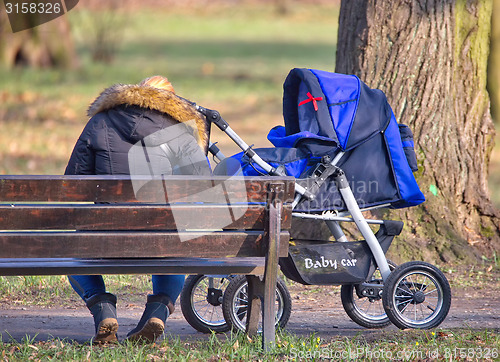 Image of Young mother with  pram 