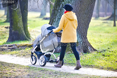 Image of Young mother with  pram 