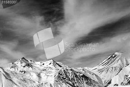 Image of Black and white snowy mountains in windy day