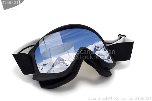 Image of Ski goggles with reflection of mountains at sunny day