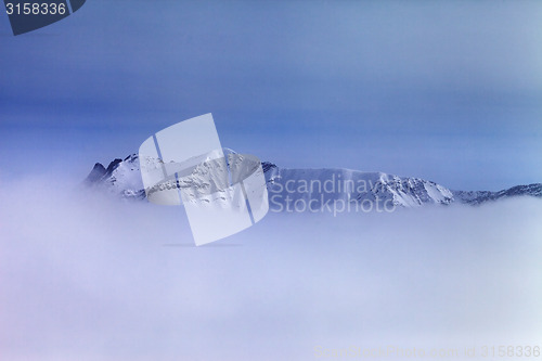 Image of Snowy mountains in fog