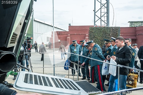 Image of Officers of Kazakh army examine troop-carrier