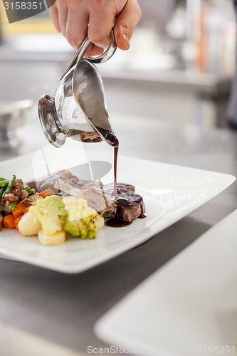 Image of Chef plating up food in a restaurant