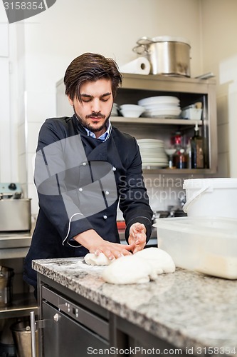 Image of Chef tossing dough while making pastries