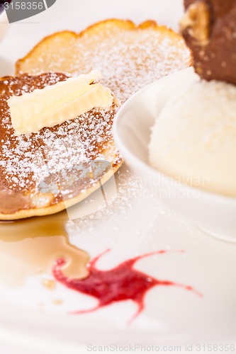Image of tasty sweet pancakes with vanilla icecream and topping