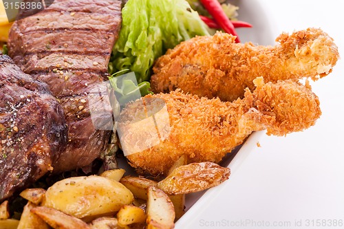 Image of Platter of mixed meats, salad and French fries