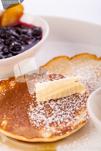 Image of tasty sweet pancakes with vanilla icecream and topping