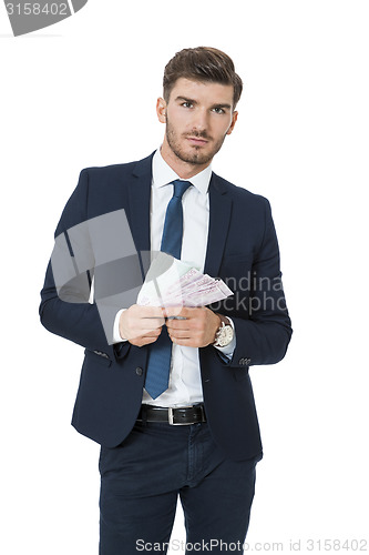 Image of Wealthy successful businessman burning money