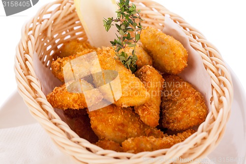 Image of Crumbed chicken nuggets in a basket