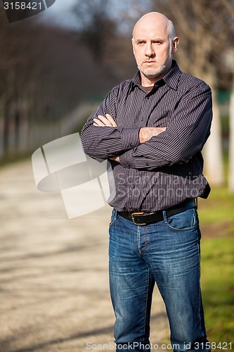 Image of Confident attractive man standing waiting