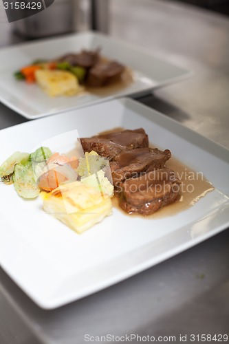 Image of Chef plating up food in a restaurant