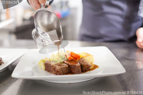Image of Chef plating up food in a restaurant