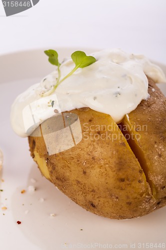 Image of Baked jacket potato with sour cream sauce