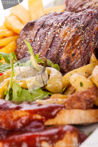 Image of Platter of mixed meats, salad and French fries