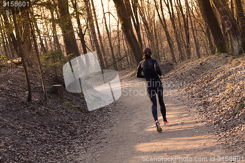 Image of Female runner in the forest. 