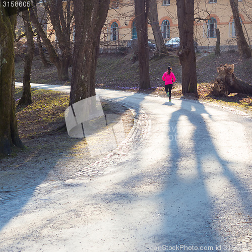 Image of Female runner in the forest. 