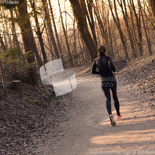 Image of Female runner in the forest. 