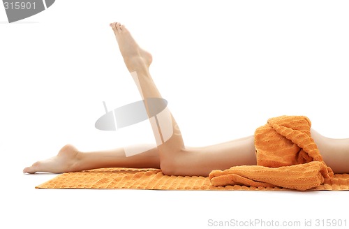 Image of long legs of relaxed lady with orange towel #2