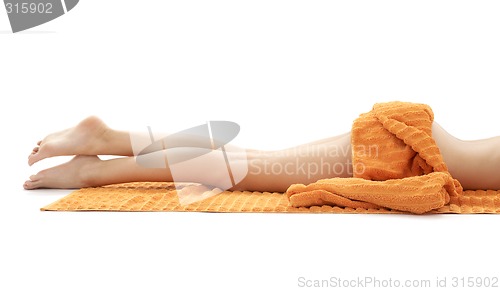 Image of long legs of relaxed lady with orange towel #3