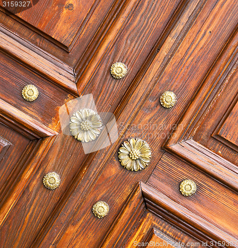 Image of abstract  rusty brass brown   closed wood door crenna gallarate 