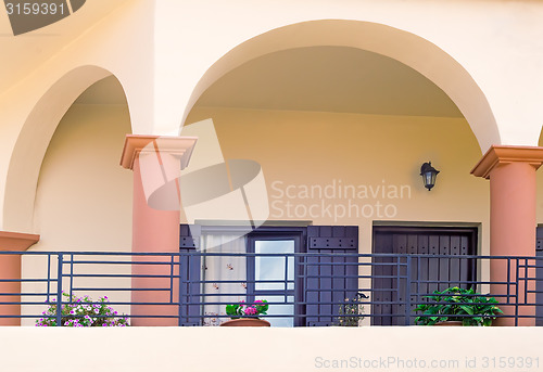 Image of Detail of the facade of an old house with balconies and a sun aw