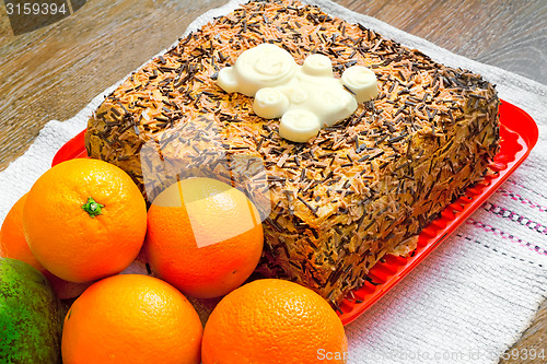 Image of Delicious cake on a platter and fruit.