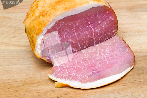 Image of Delicious smoked meat on the table surface.