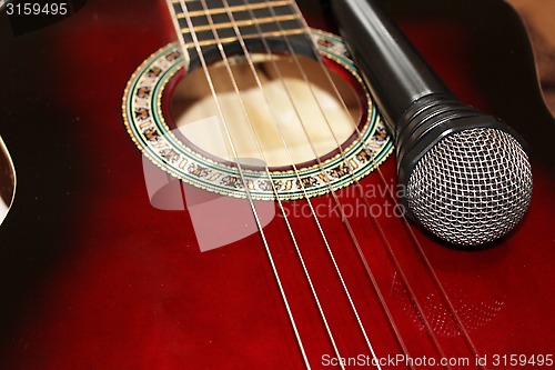 Image of dark guitar and microphone
