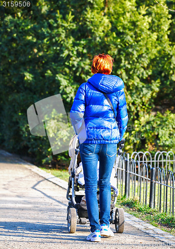 Image of Young mother with  pram 