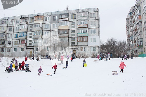 Image of children are sleding from the hill