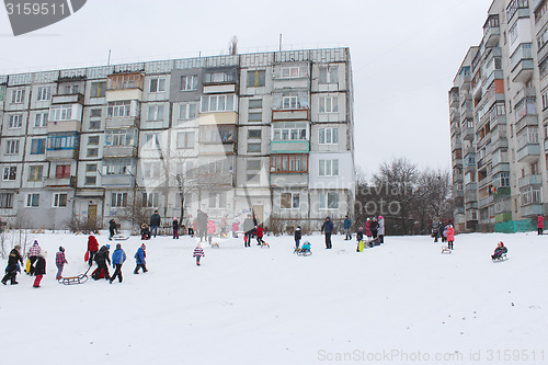 Image of children are sleding from the hill
